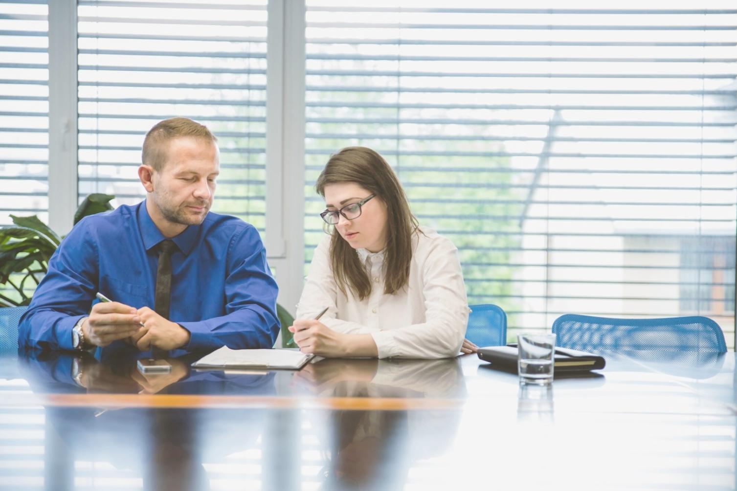 Professional financial analyst reviewing complex data visualization tools and measurement frameworks